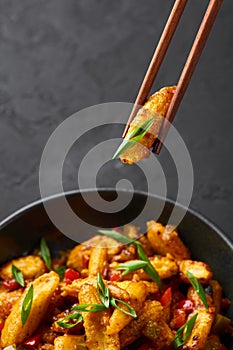 Baby Corn Manchurian dry looks like Schezwan Baby Corn in black bowl at dark slate background