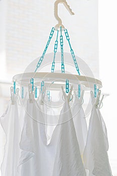 Baby cotton diapers hanging on plastic white cloth clamp for sun
