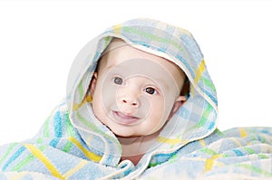 Baby covered by a blue blanket on a white background