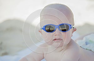 A baby is covered with sunscreen at the beach in Mexico photo