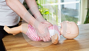 Baby CPR two hand compression