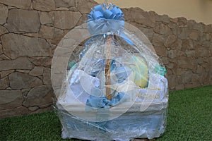 Baby cradle wrapped in a plastic gift bag with a nametag Alvaro on it photo