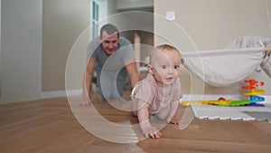 baby crawl first steps. dad play a baby toddler take crawl at home. happy family kid dream concept. baby son learning to