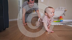 Baby crawl first steps. Dad play a baby toddler take crawl at home. Happy family kid dream concept. Baby son learning to