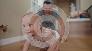 Baby crawl first steps. Dad play a baby toddler take crawl at home. Happy family kid dream concept. Baby son learning to