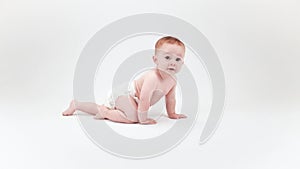 Baby crawling across a white background