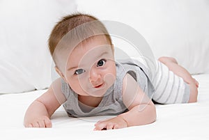 Baby crawling on the bed.