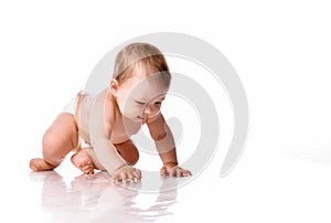 Baby crawling on floor over white studio copyspace