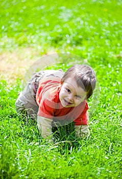 Baby crawling in grass