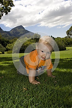 Baby crawling on grass outdoors