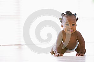 Baby crawling indoors photo