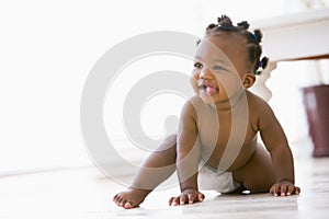 Baby crawling indoors smiling