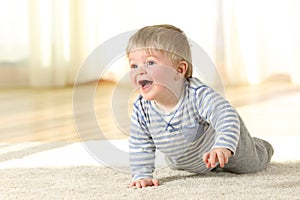Baby crawling and laughing on the floor at home