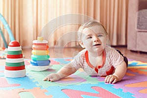 Baby crawling on playmat. Early education development photo