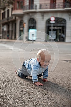 Baby crawling on the street and smiling