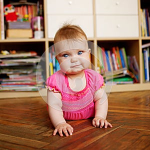 Baby crawling on the wooden floor