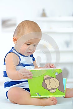 Baby curious with book