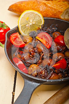 Baby cuttle fish roasted on iron skillet