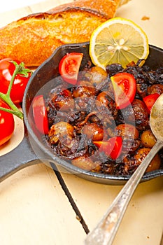 Baby cuttle fish roasted on iron skillet