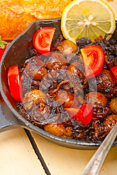 Baby cuttle fish roasted on iron skillet