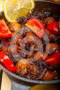 Baby cuttle fish roasted on iron skillet