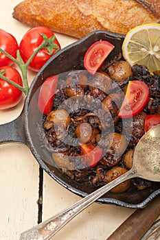 Baby cuttle fish roasted on iron skillet