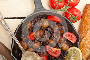 Baby cuttle fish roasted on iron skillet