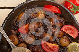 Baby cuttle fish roasted on iron skillet