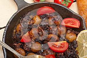 Baby cuttle fish roasted on iron skillet