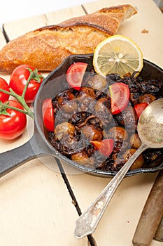 Baby cuttle fish roasted on iron skillet