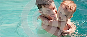 Baby with dad swimming in the pool