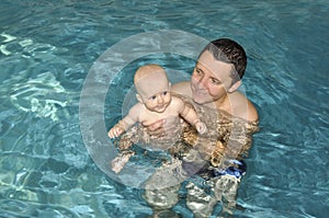 Baby with daddy in swimmingpool