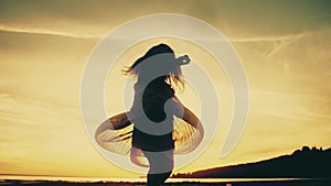 Baby dancing and enjoying nature on sunset. Child`s silhouette. Slow motion.