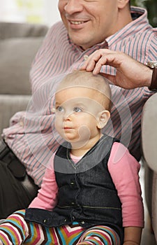 Baby daughter sitting with dad