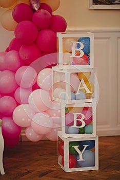 Baby decorations and pink balloons