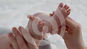 Baby Development Stimulation. Mother Touching Tiny Legs Of Her Newborn Child