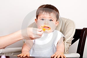 Baby dislikes food expressing disgust photo