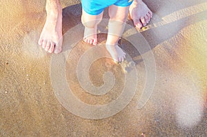 Baby doing his first steps on the beach