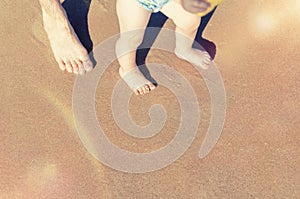 Baby doing his first steps on the beach