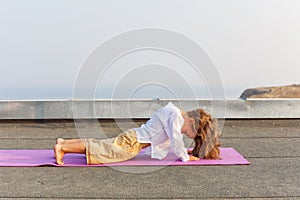 Baby doing yoga on the roof