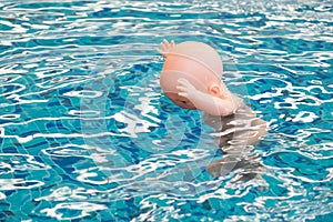 Baby doll floating in a swimming pool, The dangers of children d