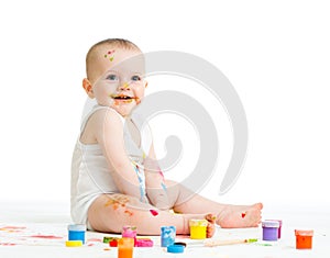 Baby drawing with a finger's paints