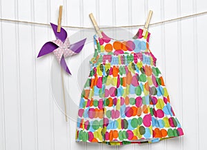 Baby Dress and Pinwheel on a Clothesline