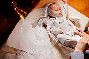 The baby dress up in clothes on the table in the Church. ordinance of baptism.