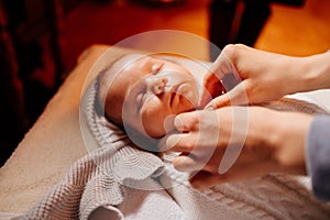 The baby dress up in clothes on the table in the Church. ordinance of baptism.