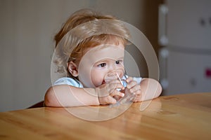 Baby drink water. Cute little child drinks water.