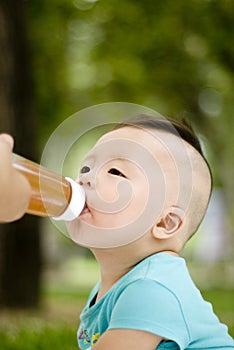 Baby drinking fruit juice