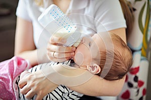 Baby drinking milk from bottle