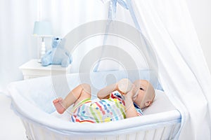 Baby drinking milk. Boy with formula bottle in bed