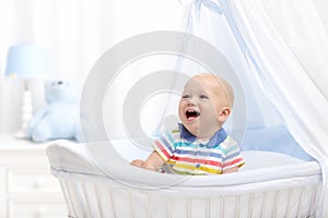 Baby drinking milk. Boy with formula bottle in bed